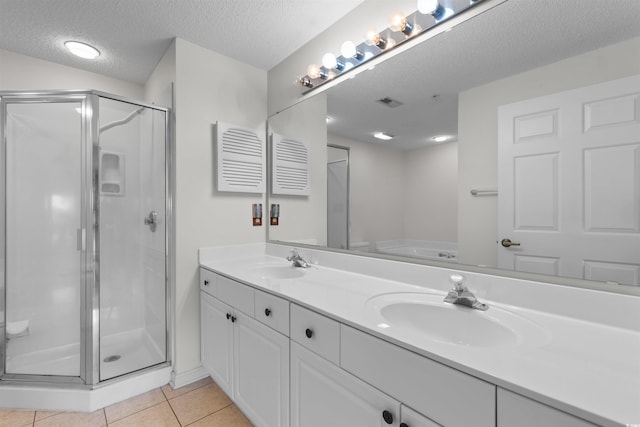 1551 Spinnaker Dr Unit 5935, North Myrtle Beach, SC 29582 - full bathroom with double vanity, a stall shower, tile patterned floors, a textured ceiling, and a bath