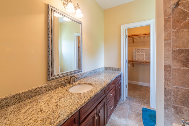4302 Grande Harbour Blvd Unit 4302, Little River, SC 29566 - bathroom featuring vanity, stone finish flooring, and a spacious closet