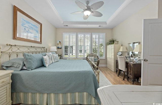 216 Coral Beach Cir, Myrtle Beach, SC 29575 - bedroom with wood finished floors, a tray ceiling, crown molding, ceiling fan, and an office area