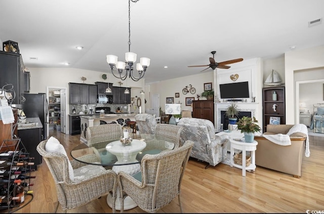 216 Coral Beach Cir, Myrtle Beach, SC 29575 - dining area featuring a ceiling fan, light wood finished floors, and a chandelier