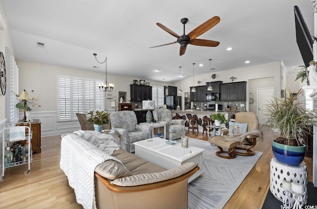 216 Coral Beach Cir, Myrtle Beach, SC 29575 - living area featuring a ceiling fan, light wood-type flooring, a wainscoted wall, a chandelier, and recessed lighting