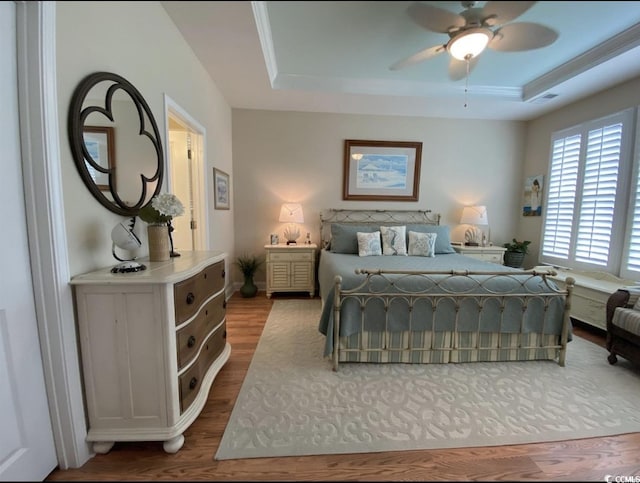 216 Coral Beach Cir, Myrtle Beach, SC 29575 - bedroom featuring a raised ceiling and wood finished floors