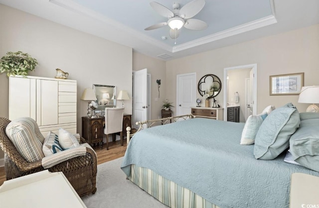 216 Coral Beach Cir, Myrtle Beach, SC 29575 - bedroom with a tray ceiling, wood finished floors, crown molding, connected bathroom, and a ceiling fan