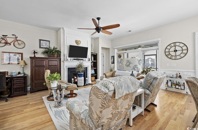 216 Coral Beach Cir, Myrtle Beach, SC 29575 - living room featuring a ceiling fan, a glass covered fireplace, light wood-style floors, and a desk