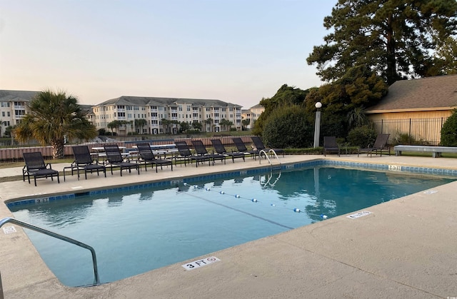 964 Oakwood Ln, Myrtle Beach, SC 29572 - pool at dusk featuring a community pool and a patio