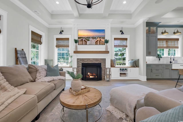 1320 James Island Ave, North Myrtle Beach, SC 29582 - living room with beamed ceiling, light wood-style flooring, recessed lighting, ornamental molding, and a brick fireplace