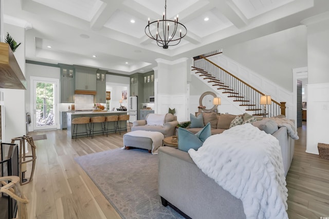 1320 James Island Ave, North Myrtle Beach, SC 29582 - living area with coffered ceiling, stairway, a decorative wall, a chandelier, and light wood-style floors