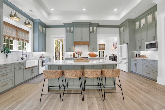 1320 James Island Ave, North Myrtle Beach, SC 29582 - kitchen with white appliances, a raised ceiling, tasteful backsplash, and recessed lighting