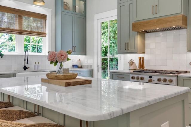 1320 James Island Ave, North Myrtle Beach, SC 29582 - kitchen featuring gas stovetop, custom exhaust hood, decorative backsplash, and plenty of natural light