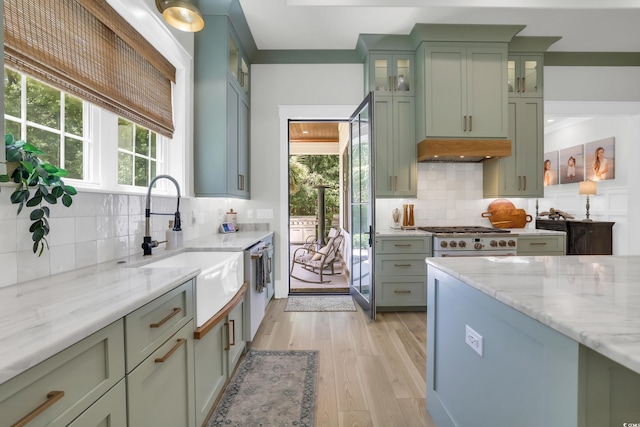 1320 James Island Ave, North Myrtle Beach, SC 29582 - kitchen with green cabinets, decorative backsplash, light wood-style floors, and light stone countertops