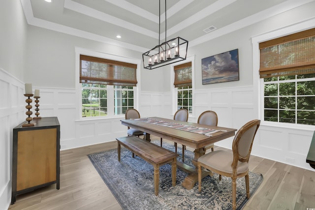 1320 James Island Ave, North Myrtle Beach, SC 29582 - dining area featuring a decorative wall, plenty of natural light, a chandelier, wainscoting, and light wood-type flooring