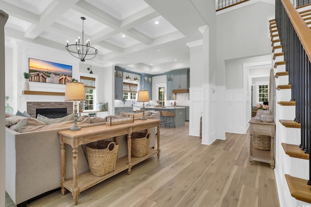 1320 James Island Ave, North Myrtle Beach, SC 29582 - living area with a high ceiling, beam ceiling, light wood-style floors, stairway, and healthy amount of natural light