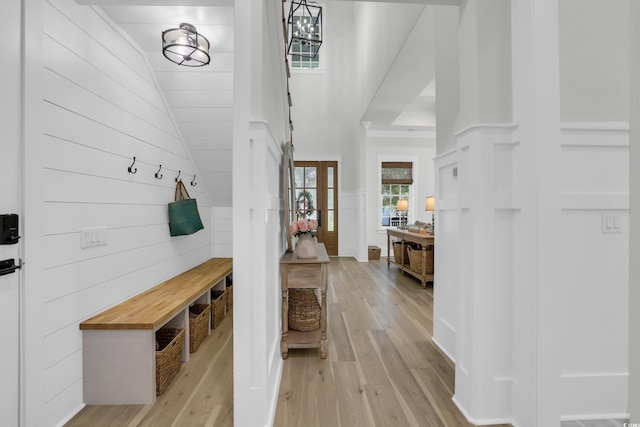 1320 James Island Ave, North Myrtle Beach, SC 29582 - mudroom featuring light wood-style flooring, wooden walls, and high vaulted ceiling