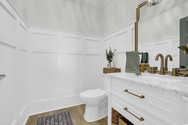 1320 James Island Ave, North Myrtle Beach, SC 29582 - bathroom featuring a decorative wall, vanity, a wainscoted wall, and wood finished floors