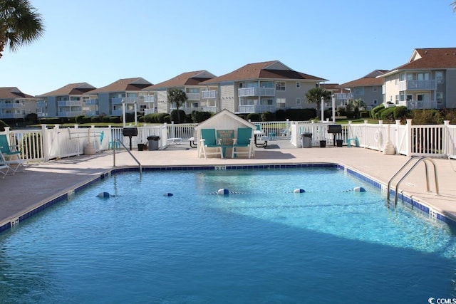 1919 Spring St Unit A-24, North Myrtle Beach, SC 29582 - community pool featuring a residential view and a patio
