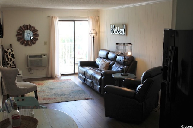1919 Spring St Unit A-24, North Myrtle Beach, SC 29582 - living area with wood-type flooring, an AC wall unit, and a textured ceiling