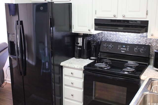 1919 Spring St Unit A-24, North Myrtle Beach, SC 29582 - kitchen featuring black appliances, under cabinet range hood, white cabinets, decorative backsplash, and light stone countertops