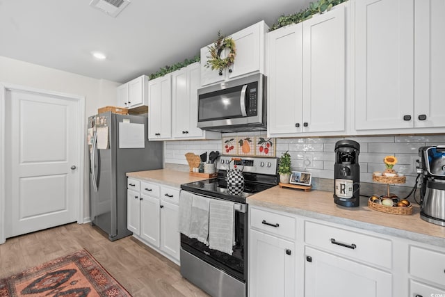 358 Spruce Pine Way, Conway, SC 29526 - kitchen with stainless steel appliances, light countertops, white cabinetry, and decorative backsplash