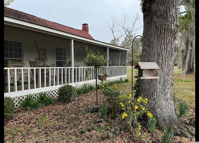 673 Brick Chimney Rd, Georgetown, SC 29440 - view of side of home with a chimney and a sunroom