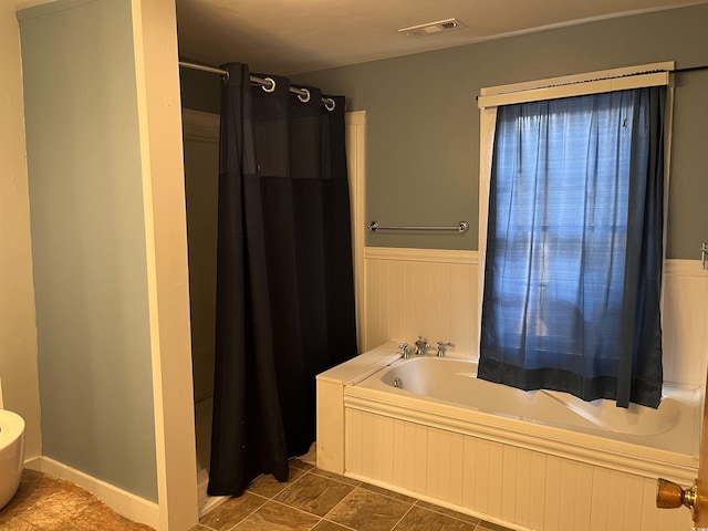673 Brick Chimney Rd, Georgetown, SC 29440 - bathroom with a bath, a wainscoted wall, and a shower with curtain