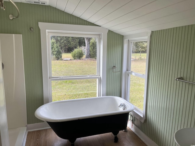 673 Brick Chimney Rd, Georgetown, SC 29440 - bathroom with lofted ceiling, a freestanding bath, and wood finished floors