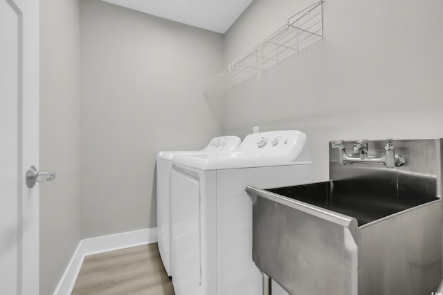330 51st Ave N, North Myrtle Beach, SC 29582 - laundry area with washing machine and clothes dryer and wood finished floors
