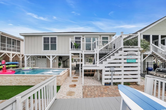 330 51st Ave N, North Myrtle Beach, SC 29582 - rear view of house featuring stairs, a deck, a patio area, and board and batten siding
