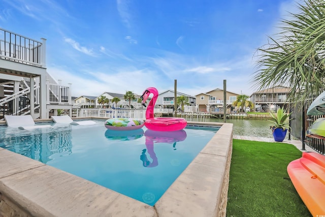 330 51st Ave N, North Myrtle Beach, SC 29582 - view of swimming pool featuring a yard, a residential view, and a water view