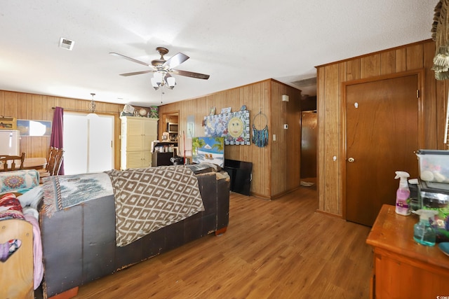4233 Mica Ave, Little River, SC 29566 - living area featuring wood walls, ceiling fan, and wood finished floors