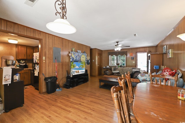 4233 Mica Ave, Little River, SC 29566 - dining room featuring wood walls, light wood-style flooring, ceiling fan, and electric panel