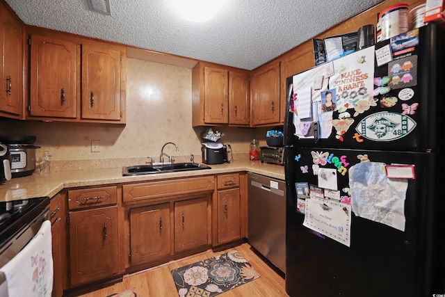 4233 Mica Ave, Little River, SC 29566 - kitchen with freestanding refrigerator, dishwasher, electric range oven, a textured ceiling, and light countertops