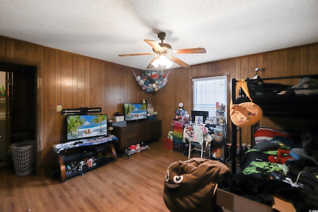 4233 Mica Ave, Little River, SC 29566 - interior space with a ceiling fan, wood finished floors, a textured ceiling, and wooden walls