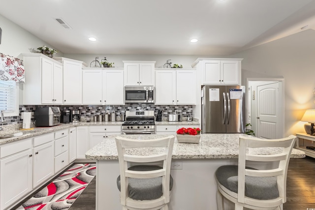 116 Olympus Ln, Conway, SC 29527 - kitchen with appliances with stainless steel finishes, white cabinets, decorative backsplash, dark wood finished floors, and recessed lighting