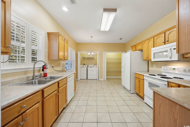 3484 Trailside Dr, Little River, SC 29566 - kitchen with white appliances, washing machine and clothes dryer, decorative light fixtures, and light countertops