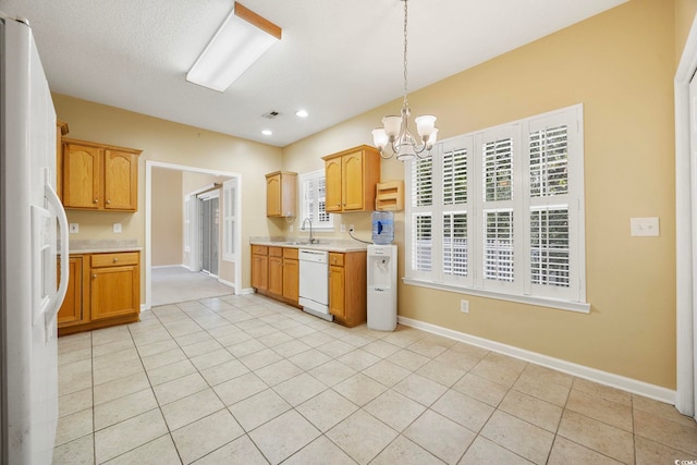 3484 Trailside Dr, Little River, SC 29566 - kitchen with white appliances, light countertops, a chandelier, hanging light fixtures, and light tile patterned floors