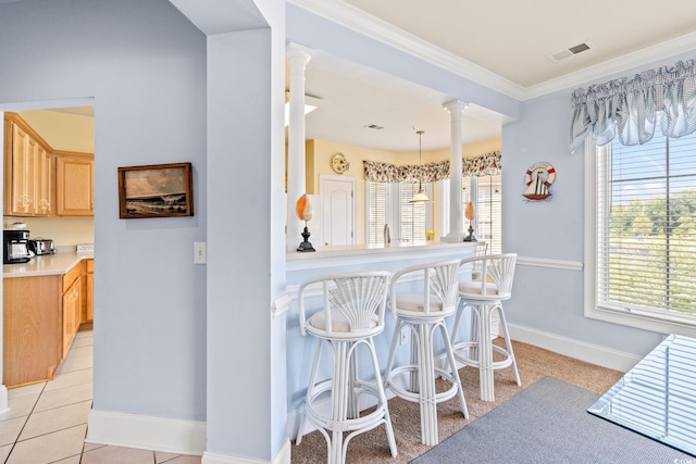 2180 Waterview Dr Unit 332, North Myrtle Beach, SC 29582 - kitchen with ornate columns, healthy amount of natural light, ornamental molding, and light brown cabinetry