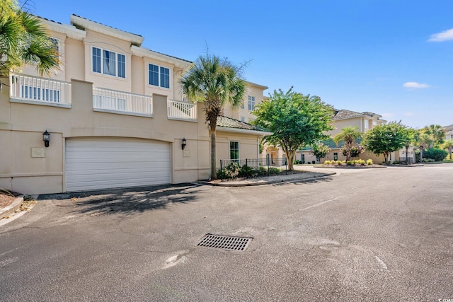 2180 Waterview Dr Unit 332, North Myrtle Beach, SC 29582 - view of front of home featuring an attached garage, stucco siding, a tile roof, and asphalt driveway