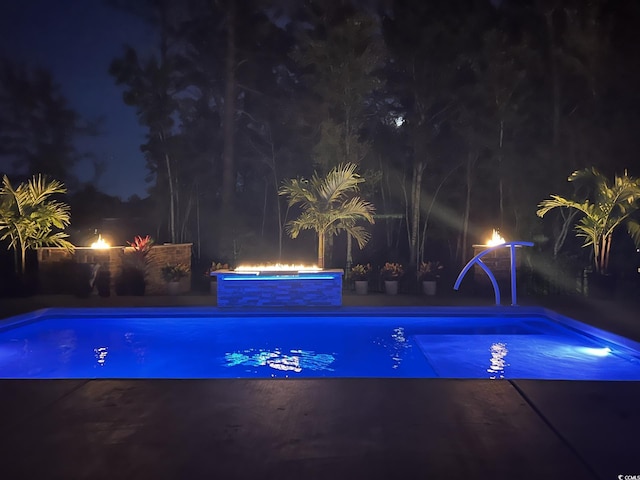 405 Palo Verde Dr, Myrtle Beach, SC 29579 - pool at twilight featuring a patio area and an outdoor pool