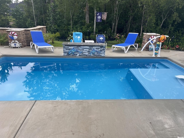 405 Palo Verde Dr, Myrtle Beach, SC 29579 - view of pool featuring a patio area and a forest view