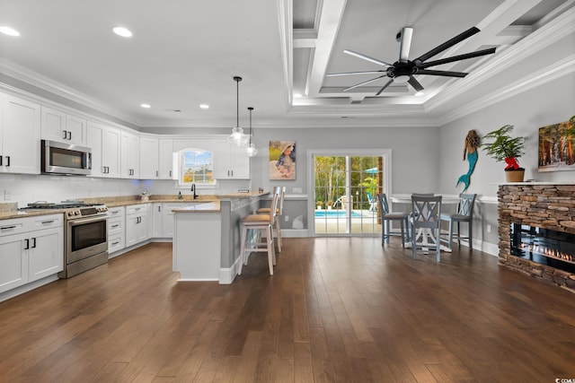 405 Palo Verde Dr, Myrtle Beach, SC 29579 - kitchen featuring stainless steel appliances, a kitchen bar, ceiling fan, crown molding, and white cabinets