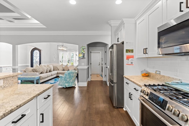 405 Palo Verde Dr, Myrtle Beach, SC 29579 - kitchen with appliances with stainless steel finishes, arched walkways, white cabinetry, a chandelier, and light stone countertops