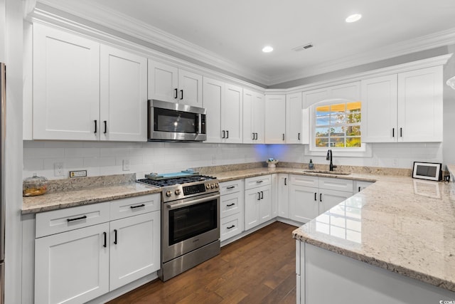 405 Palo Verde Dr, Myrtle Beach, SC 29579 - kitchen with appliances with stainless steel finishes, white cabinetry, dark wood finished floors, crown molding, and recessed lighting