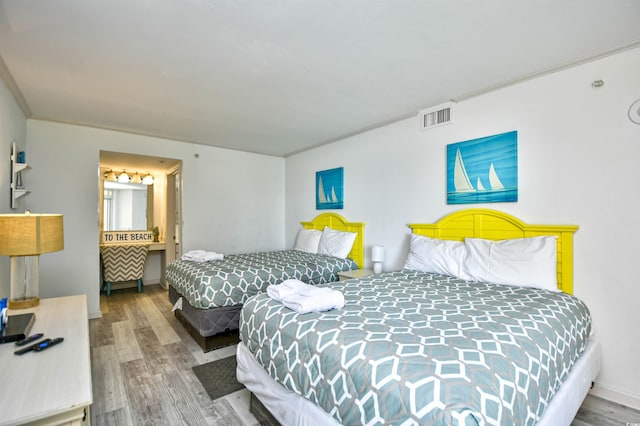 2711 S Ocean Blvd Unit 1522, North Myrtle Beach, SC 29582 - bedroom featuring wood finished floors and ensuite bath