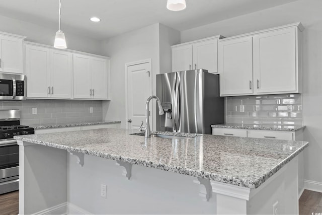 225 Astoria Park Loop, Conway, SC 29526 - kitchen with stainless steel appliances, white cabinets, decorative backsplash, a breakfast bar area, and recessed lighting