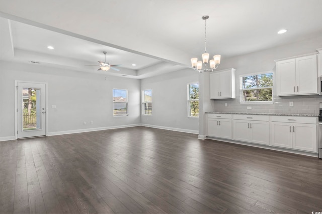225 Astoria Park Loop, Conway, SC 29526 - unfurnished living room featuring a chandelier, plenty of natural light, a raised ceiling, a ceiling fan, and recessed lighting