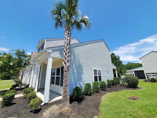 1017 Dinger Dr Unit 1017, Myrtle Beach, SC 29588 - view of home's exterior featuring covered porch and a lawn