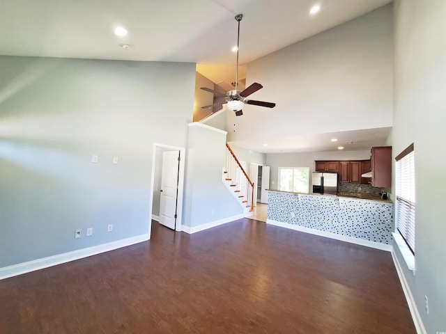 1017 Dinger Dr Unit 1017, Myrtle Beach, SC 29588 - unfurnished living room with dark wood-style flooring, a ceiling fan, recessed lighting, stairs, and a towering ceiling
