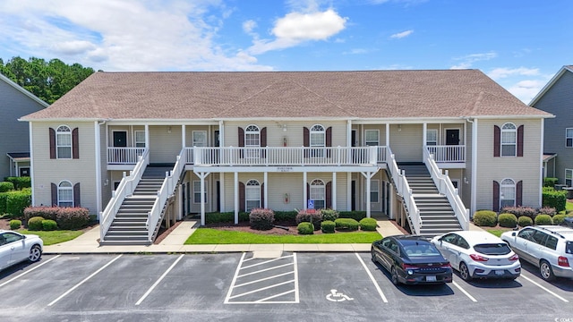 105 Ashley Park Dr Unit 2B, Myrtle Beach, SC 29579 - view of building exterior with stairway and uncovered parking