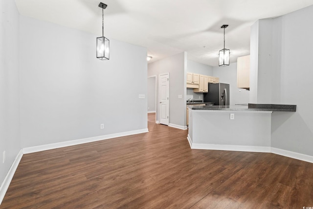 105 Ashley Park Dr Unit 2B, Myrtle Beach, SC 29579 - kitchen featuring stainless steel fridge, dark wood-style floors, hanging light fixtures, a peninsula, and dark countertops