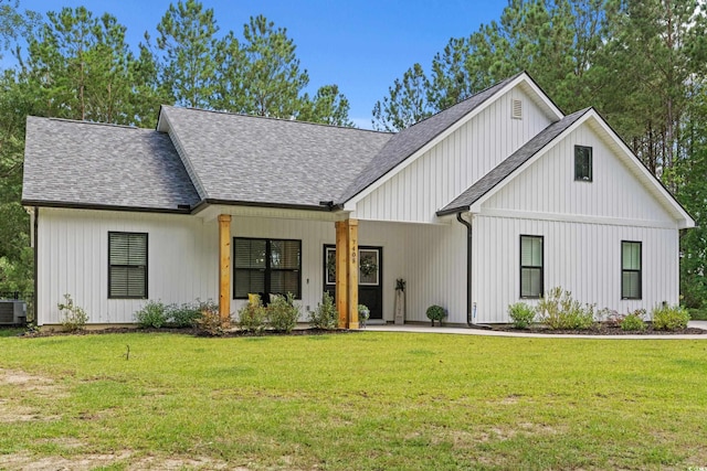 7405 Louisville Rd, Aynor, SC 29511 - modern inspired farmhouse with roof with shingles, a front lawn, and board and batten siding